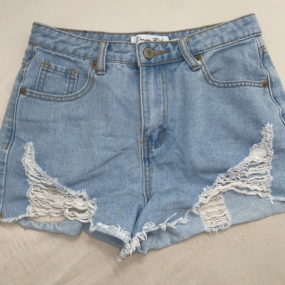 Light washed high waisted jean shorts, rips on front and back